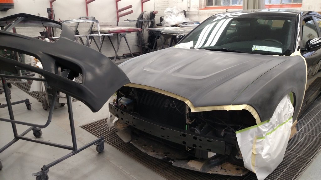 The vehicle disassembled and under repair in the shop