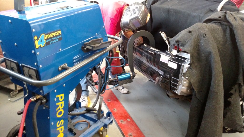 A Harden Auto Body technician welding a vehicle body panel